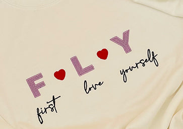 embroidered sweatshirtfly garment FLY First Love Yourself that features the phrase "FLY First Love Yourself" embroidered on the front or back.self-love and self-care